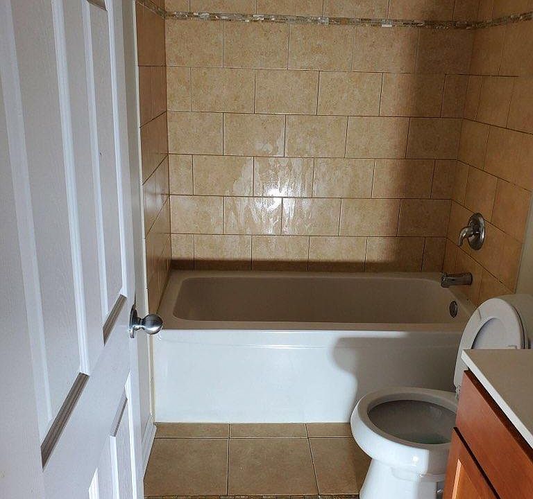 SPACIOUS BATHROOM WITH NEW TILE