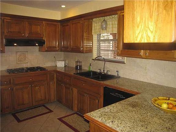 Updated kitchen with granite tile counter tops.