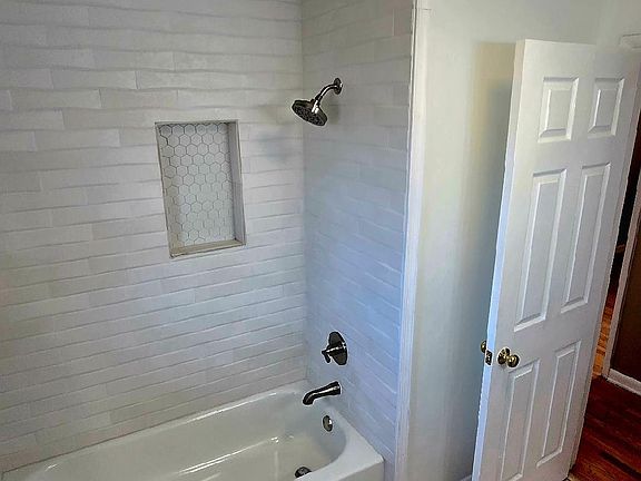 Large full bathroom with beautiful ceramic tile and thoughtful finishes, like this nook for all your bath needs.