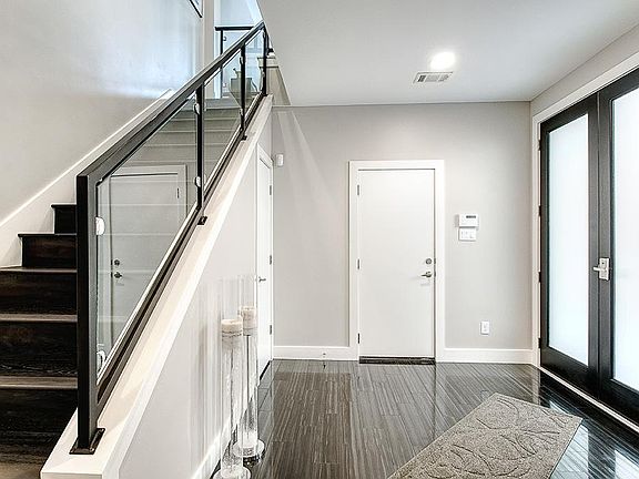 Step into a timeless contemporary as you walk onto black marble floors. The sleek Glass staircase is