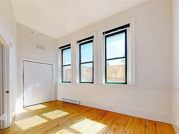 Bedroom with ample bi-fold closet and room for queen bed.