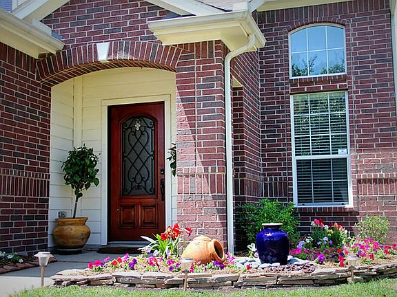 Landscaped beautifully with hardscape and lush, welcoming landscape design
