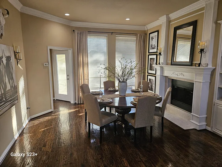 Dining room with fireplace and included table and chairs.