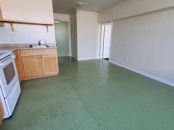 Green entrance door from secure hallway.