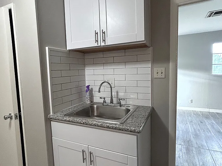 Kitchen sink with a view of the bedroom