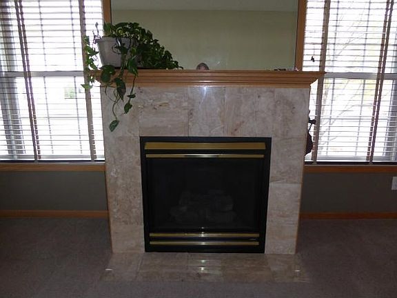 INVITING WARMTH Main living area with instant on gas fireplace that warms the room on those chilly days! Marble surround with roomy mantel!