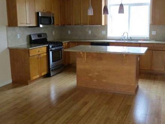 Open Kitchen to the family room Open Island kitchen with SS appliances, granite, tile backsplash& pendant lighting