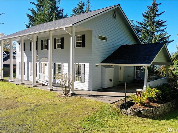Colonial style 2 story with daylight basement and attached carport with side door access.