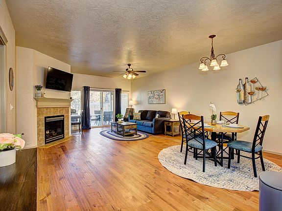 Open concept kitchen and living room with fireplace and sliding glass doors to patio and backyard