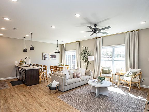 The living room area blends naturally with the dining area and kitchen to create a spacious and open floor plan, perfect for entertaining and everyday living.