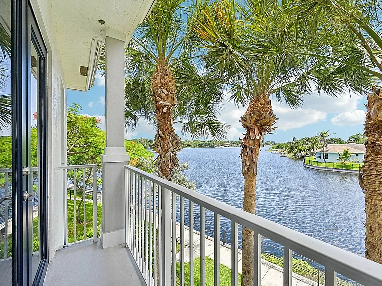 Refreshing balcony views showcasing lush palm trees and serene waterfront vistas, perfect for relaxation.