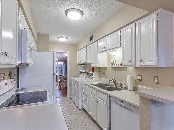 Kitchen updated with new flooring, paint, appliances and features water filtration.  Breakfast bar provides additional seating.
