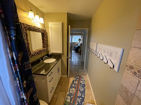 Bathroom with a tub off hall next to bunkbed room