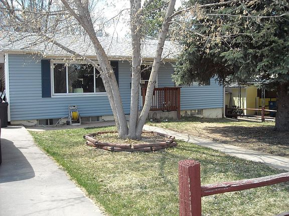 An Ash and Blue Spruce grace the front lawn