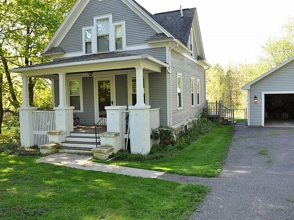 Front of house with view of garage