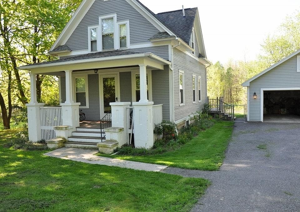 Front of house with view of garage