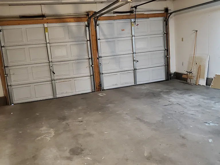 2-car garage, insulated, finished, two door openers with remote controls, shop area, cabinets