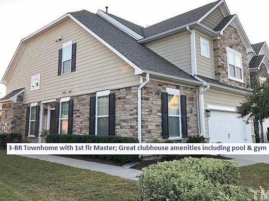 End unit with brick facing and two-car garage
