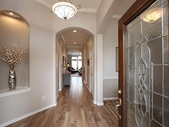 Inviting foyer with extensive wood-look tile is flanked by the study and formal dining room. Tile runs throughout all main areas.