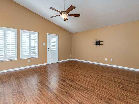 The spacious family room features a wall of windows overlooking the backyard.