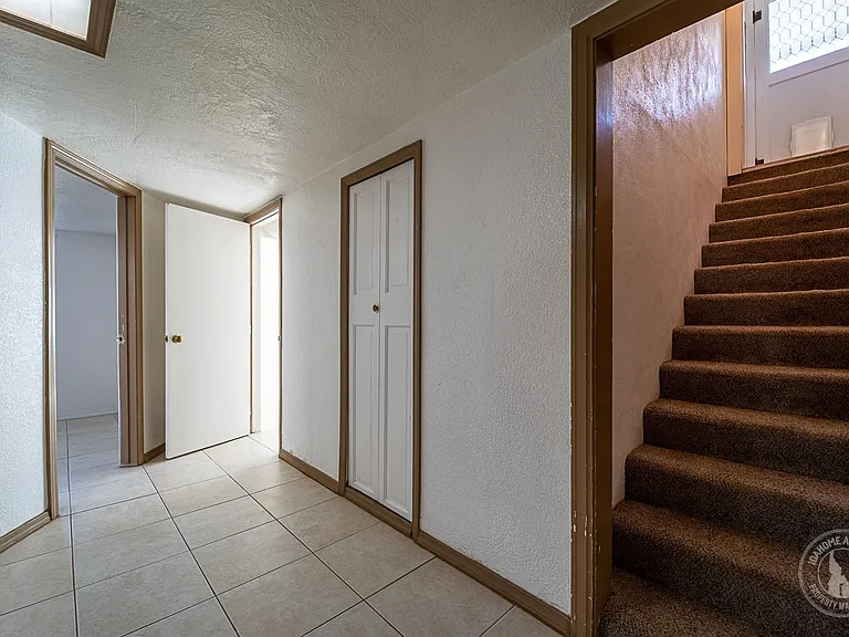 STAIRS GO TO THE EXTERIOR. THE TWO OPEN DOORS GO TO BEDROOM 1 AND 2.