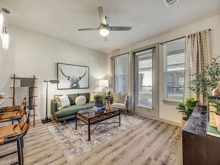 Living room with ceiling fan and natural light