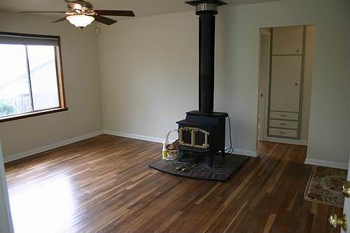 Living Room has hardwoods, wood burning fireplace, and ceiling fan/light.
