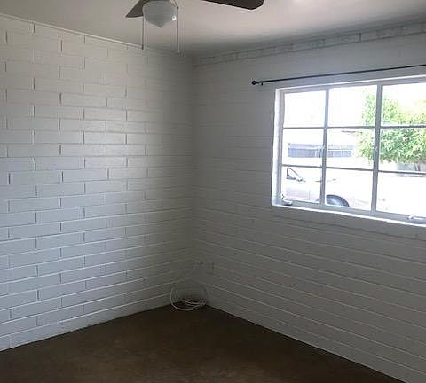 Bedroom with space for one or a couple. Mirrored closet doors and ceiling fan.