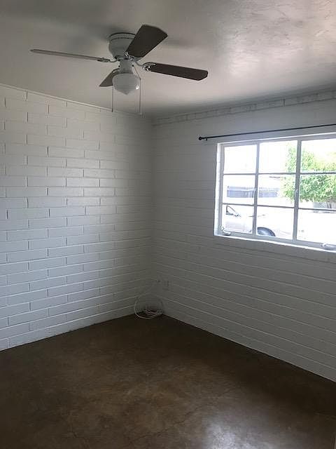 Bedroom with space for one or a couple. Mirrored closet doors and ceiling fan.