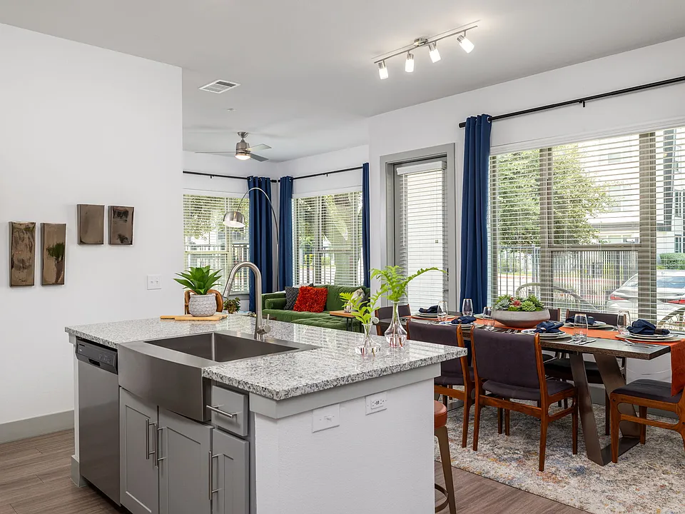 The kitchen island holds the sink, leaving the back wall free to cook on.