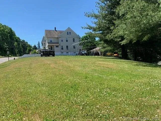 Large yard separating house from main road.