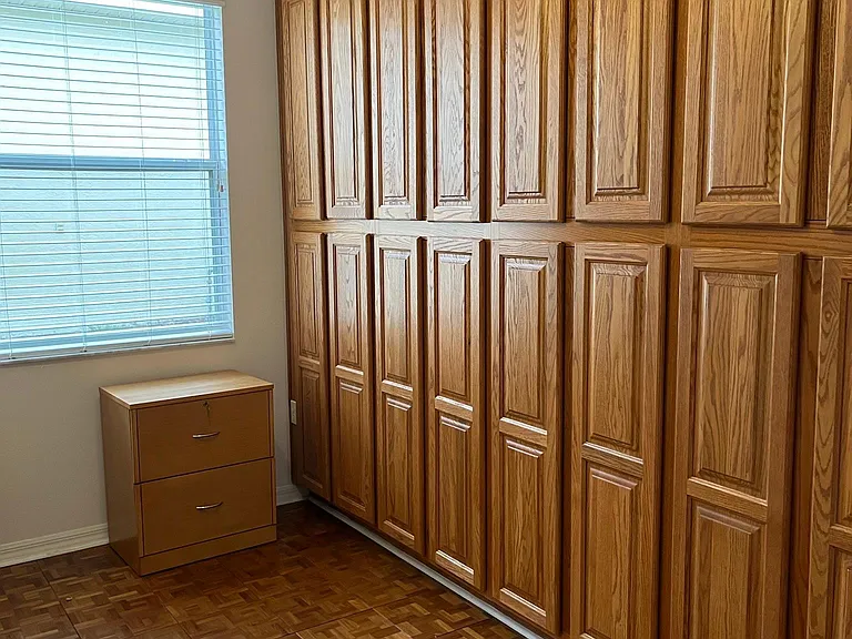 Wall of cabinets in middle bedroom.