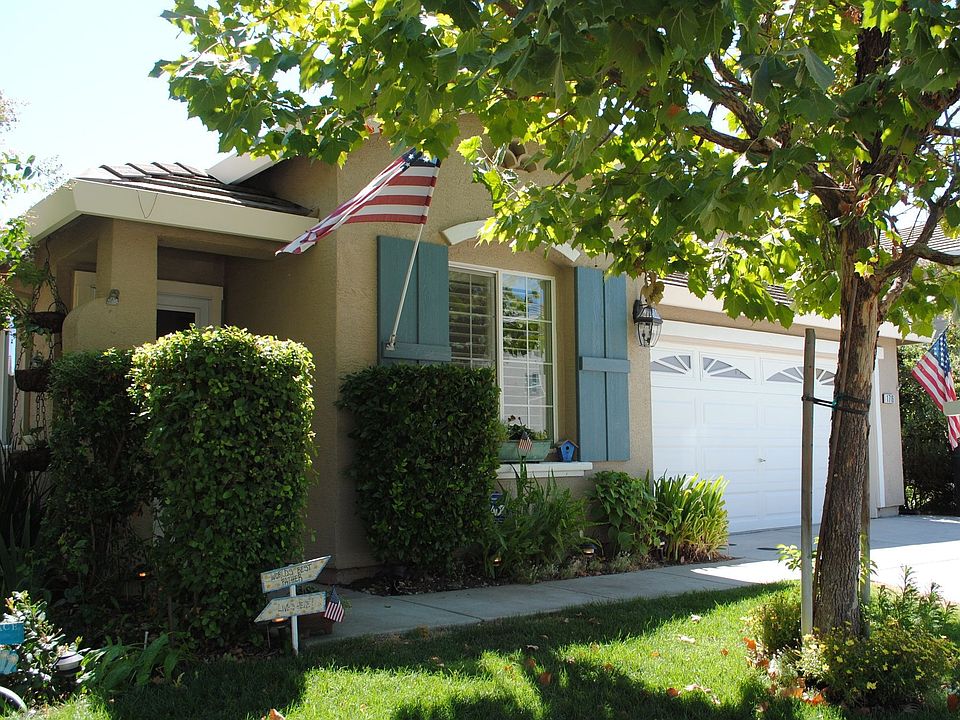 An inviting facade with mature trees and landscaping.