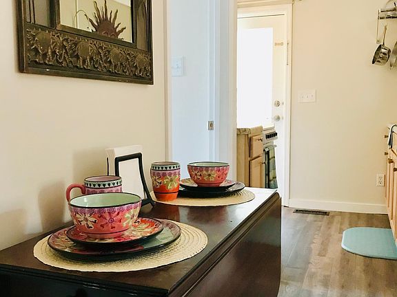 Bathroom door on left and kitchen straight ahead