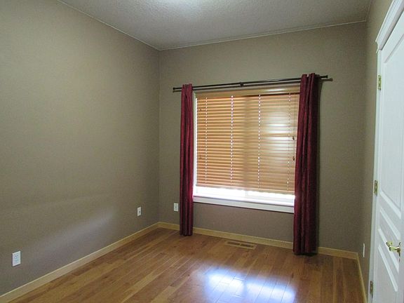 Office or sewing or small bedroom with hardwood floors and connections to internet.
