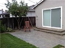 small patio, steps lead to large master bedroom