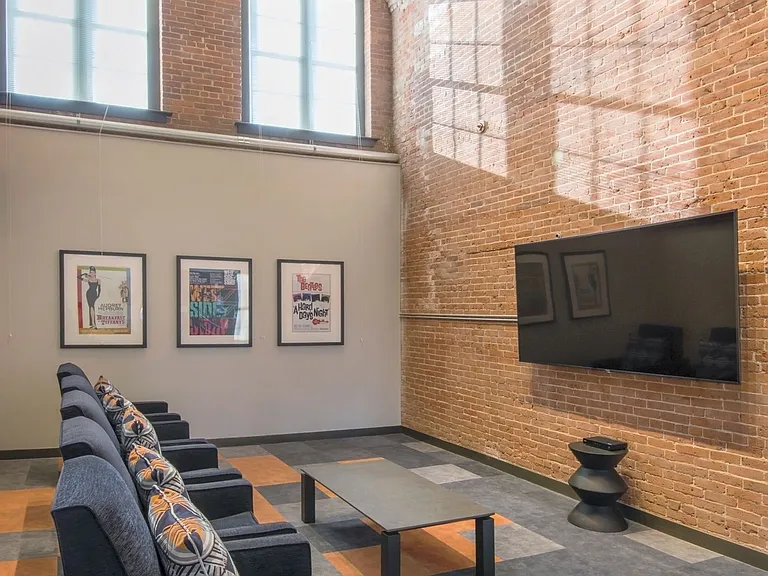 Theater Room With Cozy Chairs And Large Screen Tv.