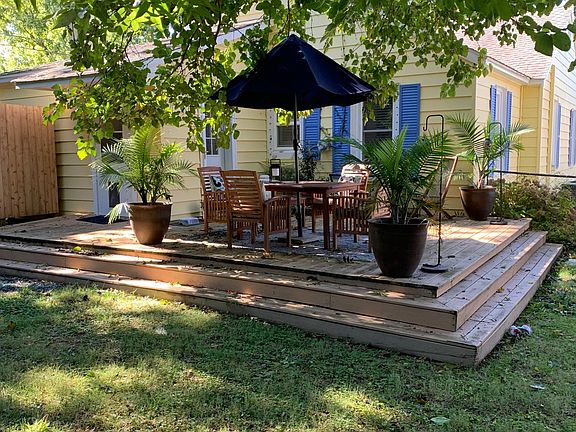 Fenced in back yard with large deck, gas grille and outdoor shower