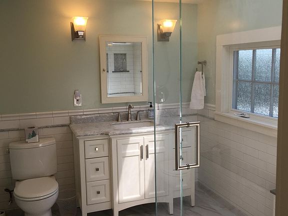 Upstairs bathroom off bedrooms was completely remodeled. Tile shower, floor, and wainscoting. Skylight provides plenty of lighting.