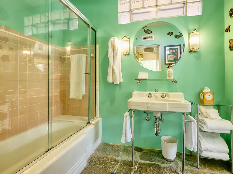 Vintage bathroom with original tub/shower combo and sink.