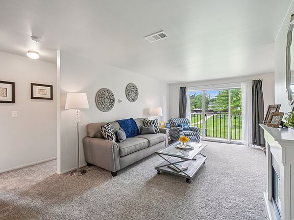 Elevated living room and private patio or balcony at Drawbridge Apartments in Harrison Township, MI.