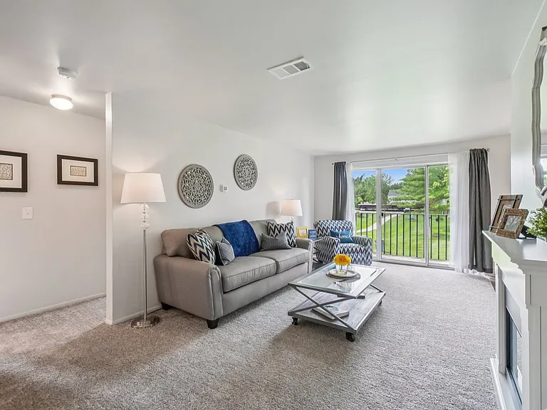 Elevated living room and private patio or balcony at Drawbridge Apartments in Harrison Township, MI.