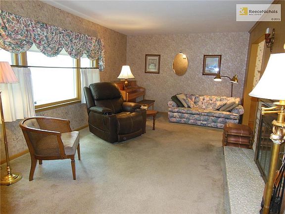 Living room has original hardwoods under the carpet.