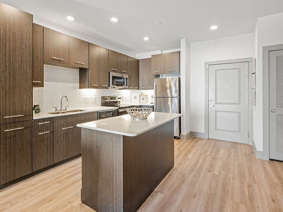 Kitchen with Brown Cabinets at Argon Apartments