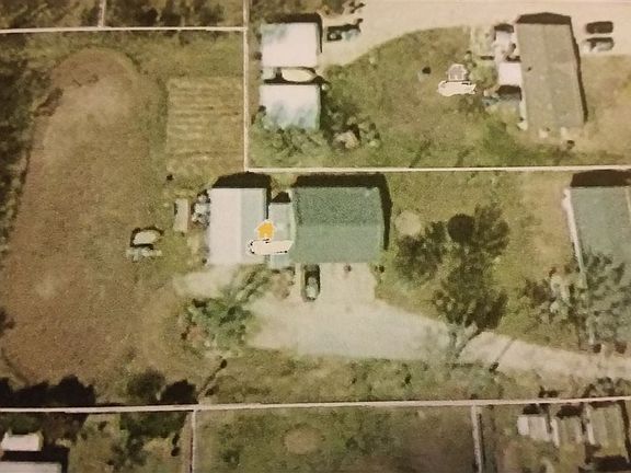 Home and 3 buildings sit on 1.2 acres