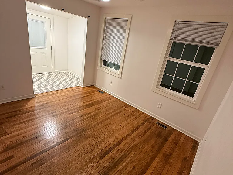 Primary bedroom with rear door to back deck. Large closet/dressing room area off bedroom.