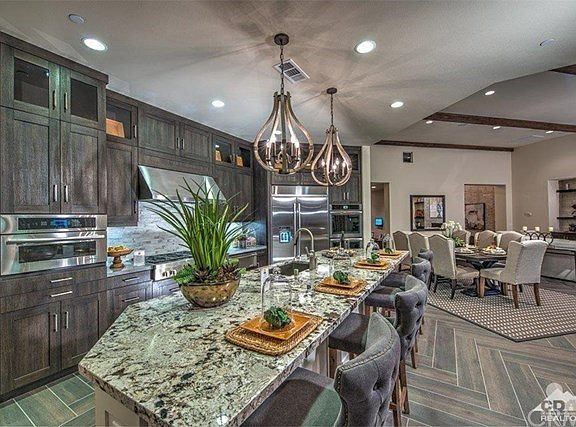 Photo of model kitchen, Plan 2 and not intended to depict the layout.  This photo is to show the Jenn-AirÂ® stainless steel appliances that are included in each home, which are:  48" Pro-styleâ„¢ cook top with 6 burners and a griddle, Built-in 30" double