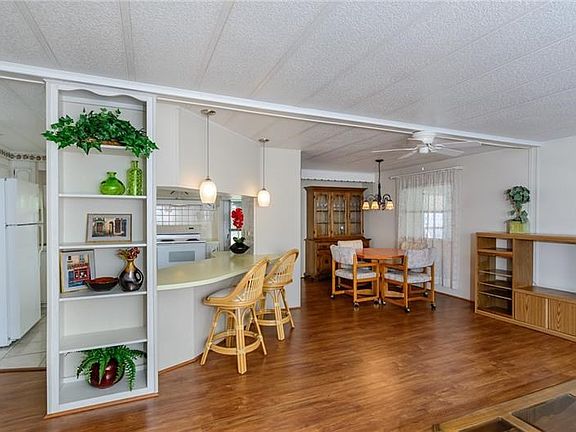 Two entrances.  One entrance between kitchen and dining room.  The other entrance is to the enclosed front porch. All laminate a