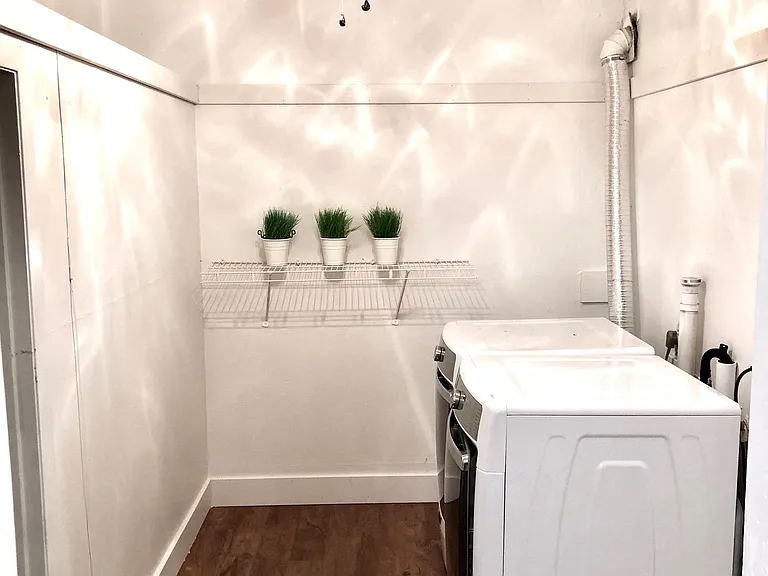 Huge laundry room with ceiling fan and commercial grade washer & dryer.