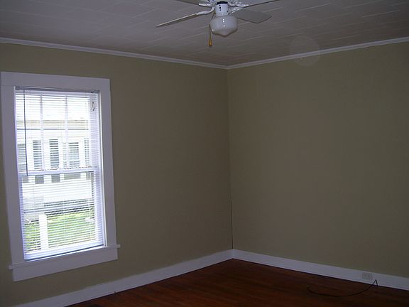 Spacious bedroom with fan.